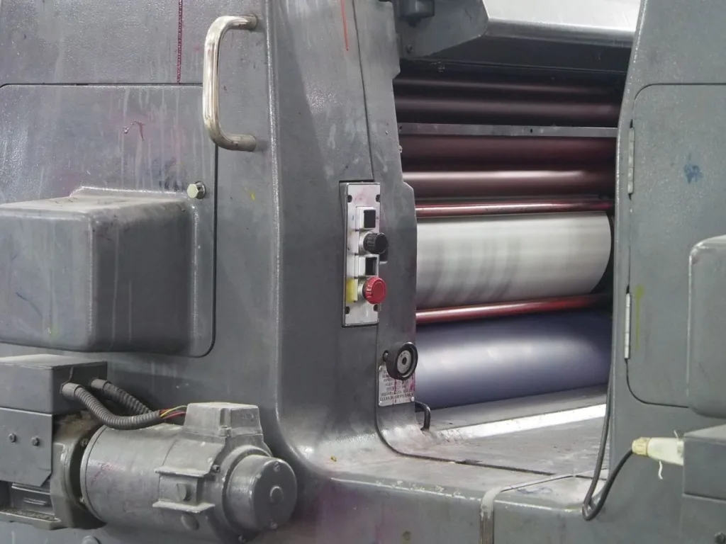 Close detail of press machinery, showing the heated plate surface a heat press relies on