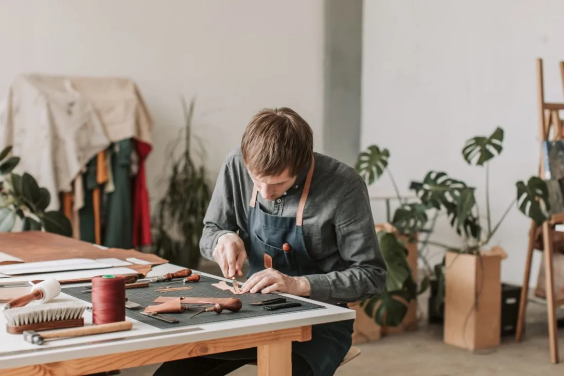 Pricing Handmade Products: 7 Proven Formulas That Beat Undercharging An artisan crafting leather goods by hand, the kind of work that needs careful pricing of handmade products