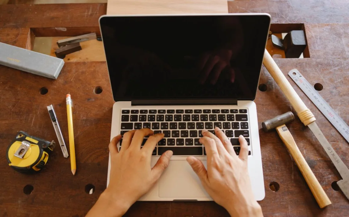 Starting a Craft Business: 9 Essential Steps That Avoid Costly Mistakes A maker at a workbench with tools and materials, the reality of starting a craft business