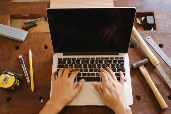 Starting a Craft Business: 9 Essential Steps That Avoid Costly Mistakes A maker at a workbench with tools and materials, the reality of starting a craft business