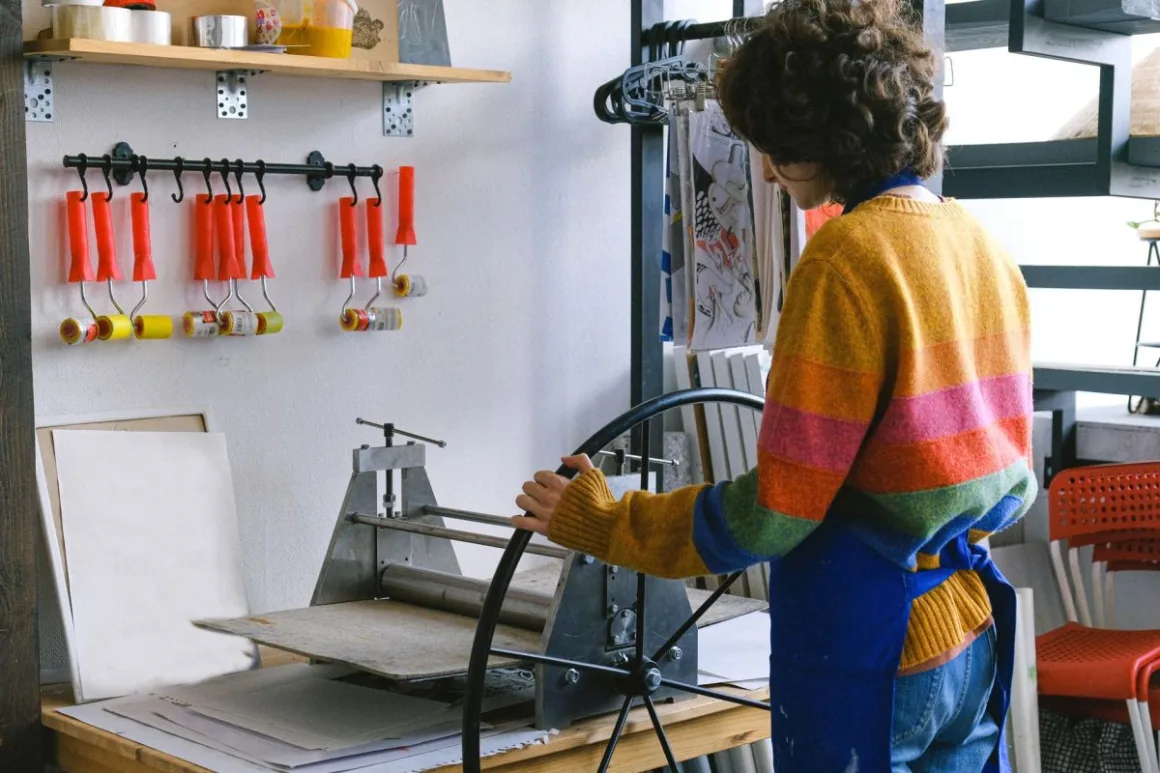 Sublimation Printing: 12 Essential Tips for Flawless Results A maker working at a printing workbench, the kind of setup used for sublimation printing